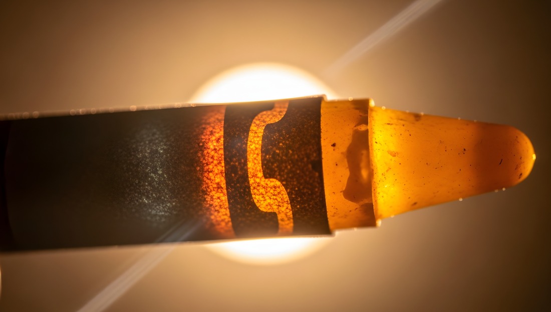 Close-up of burning moxibustion stick producing therapeutic warmth for pain relief